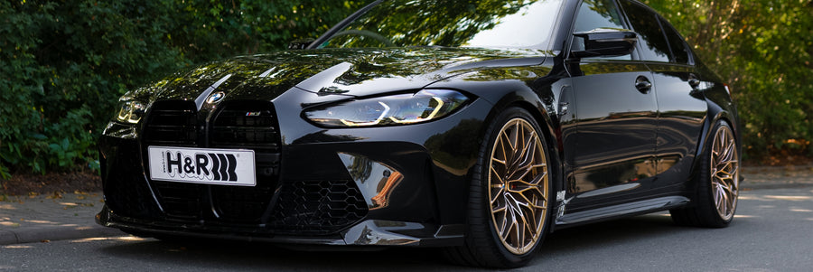 Black BMW M3 G80 lowered on H&R springs with bronze wheels
