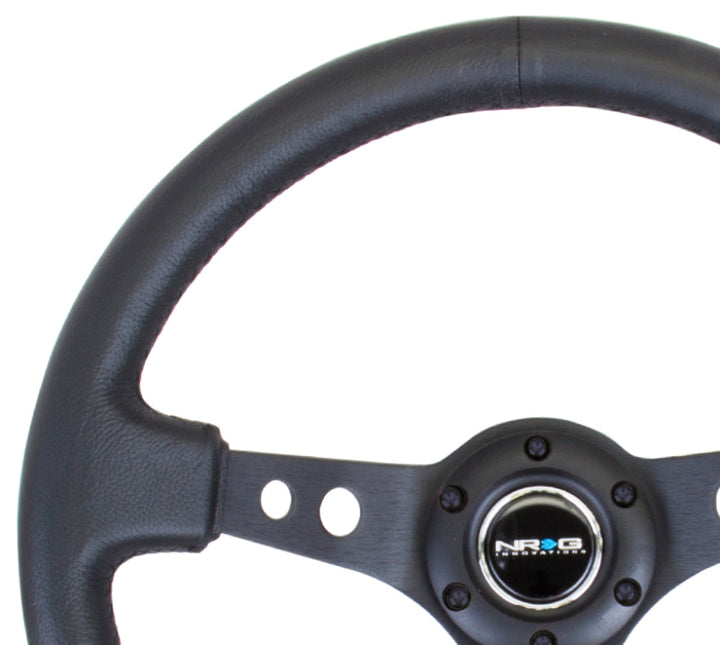 NRG Reinforced Steering Wheel (350mm / 3in. Deep) Blk Leather w/Blk Spoke & Circle Cutouts.