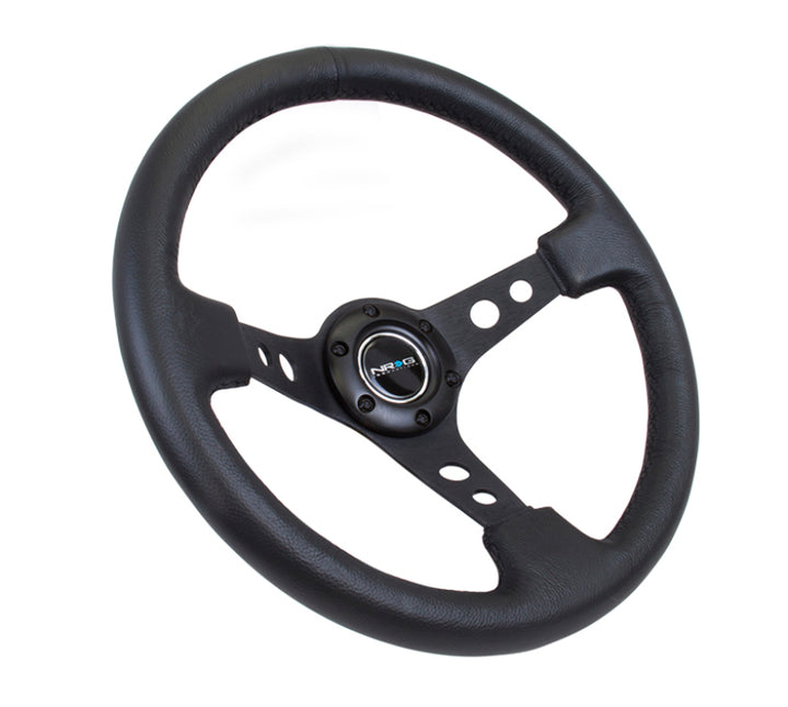 NRG Reinforced Steering Wheel (350mm / 3in. Deep) Blk Leather w/Blk Spoke & Circle Cutouts.
